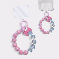 IRIDESCENT BOW AND BALL PHONE CHARMS